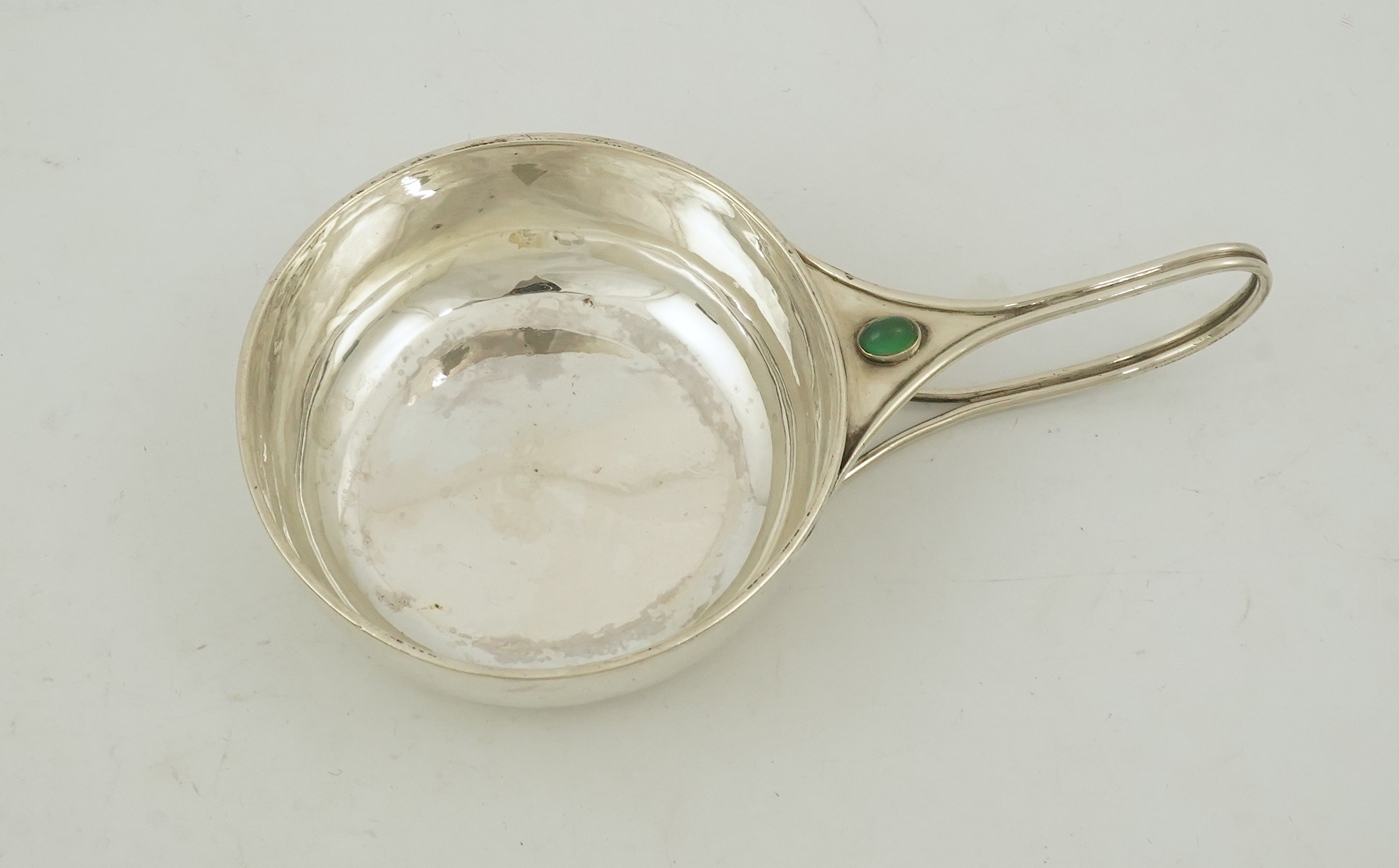 An Edwardian Arts & Crafts Charles Robert Ashbee for the Guild of Handicrafts Ltd silver and single stone cabochon chrysoprase set porringer